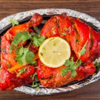 Tandoori Chicken · Tender spring chicken marinated in yogurt with a blend of imported mild spices and herbs. Se...