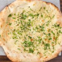 Garlic Naan · Leavened bread topped with distinct garlic flavor and baked in the clay oven.