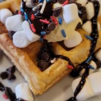 S'Mores Waffle · 1 Belgium waffle topped with mini marshmallows, mini chocolate chips, scoop of cheesecake, r...