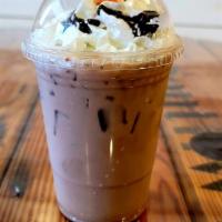 Iced Caffe Mocha · Dark Chocolate sauce, french press coffee, 2% milk and topped with cream and chocolate drizz...