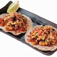 New! Vegan Chorizo Tacos · exotic grains, quinoa, roasted cauliflower, corn & bean relish, spicy roasted chickpeas, che...