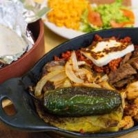 Molcajete Platillo · A big plate mixed of meat ( steak ,chicken ,chorizo,and shrimp). Served with rice, beans, an...