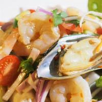 Yum Talay (Seafood Salad) · Shrimp, squid, mussel, crab meat and fish mixed with onions, tomatoes, and chili-lime dressi...