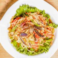 Som Tum Laos · Papaya salad with spicy lime dressing, salted crab, anchovy, green beans, carrots , tomatoes...