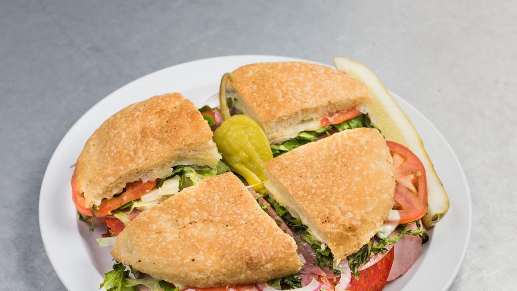 Italiano Panino · Pepperoni, salami, ham, melted provolone cheese, lettuce, tomato, and red onion. Served with our homemade Italian dressing, pickle and pepperoncini on the side.