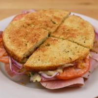 Ham Panino · Ham with melted provolone cheese, lettuce, tomato and red onion. Our homemade Italian dressi...