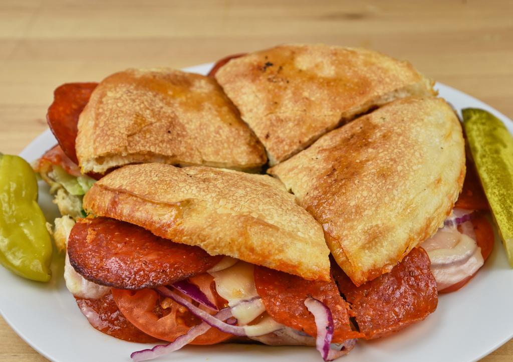 Pepperoni Panino · Imported Pepperoni with melted provolone cheese, lettuce, tomato and red onion. Our homemade Italian dressing, pickle, and pepperoncini served on the side.