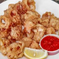Fried Calamari · Tender Calamari coated in a light tempura batter, deep-fried until golden , served with a we...