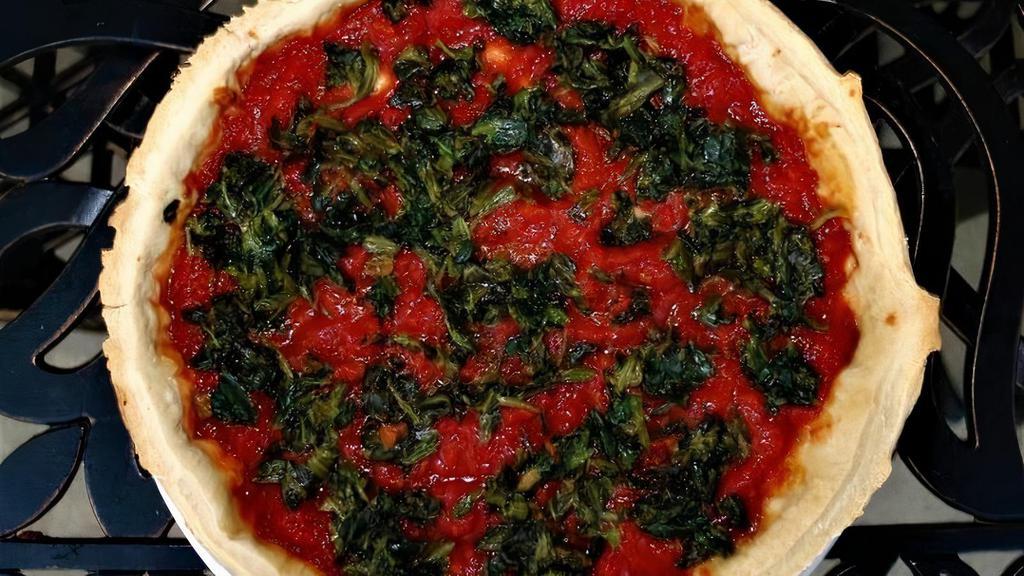 Deep Dish Spinach Pizza · Fresh spinach sautéed with butter and garlic with our homemade tomato sauce and five Italian cheese blend. A classic!