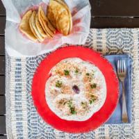 Taztziki · A yogurt dip made with grated cucumber and garlic Served with pita bread.