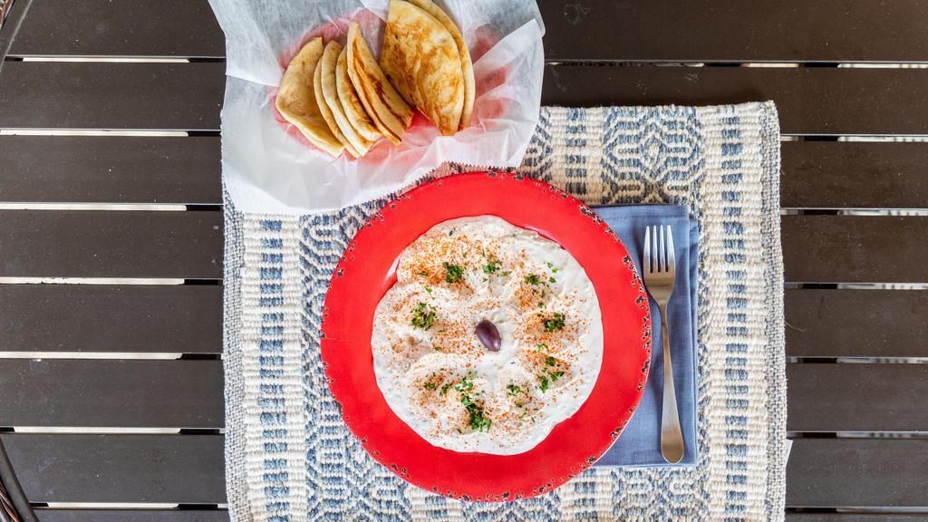 Taztziki · A yogurt dip made with grated cucumber and garlic Served with pita bread.