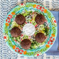 Falafel Appetizer · Spicy. Seasoned ground chick peas blended with fresh herbs and Mediterranean spices, fried t...