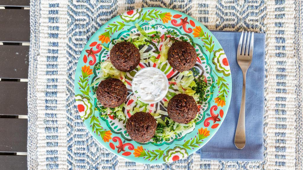 Falafel Appetizer · Spicy. Seasoned ground chick peas blended with fresh herbs and Mediterranean spices, fried to golden brown, served with tahini sauce.