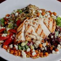 Mediterranean Chicken Salad · Grilled chicken breast julienned and set on a bed of mixed greens tossed in a lemon tahini d...
