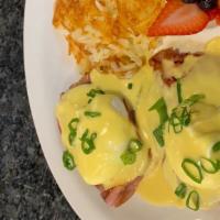 Classic Eggs Benedict · Two Poached Eggs, Ham, and Hollandaise sauce served on an english muffin with a side of Hash...
