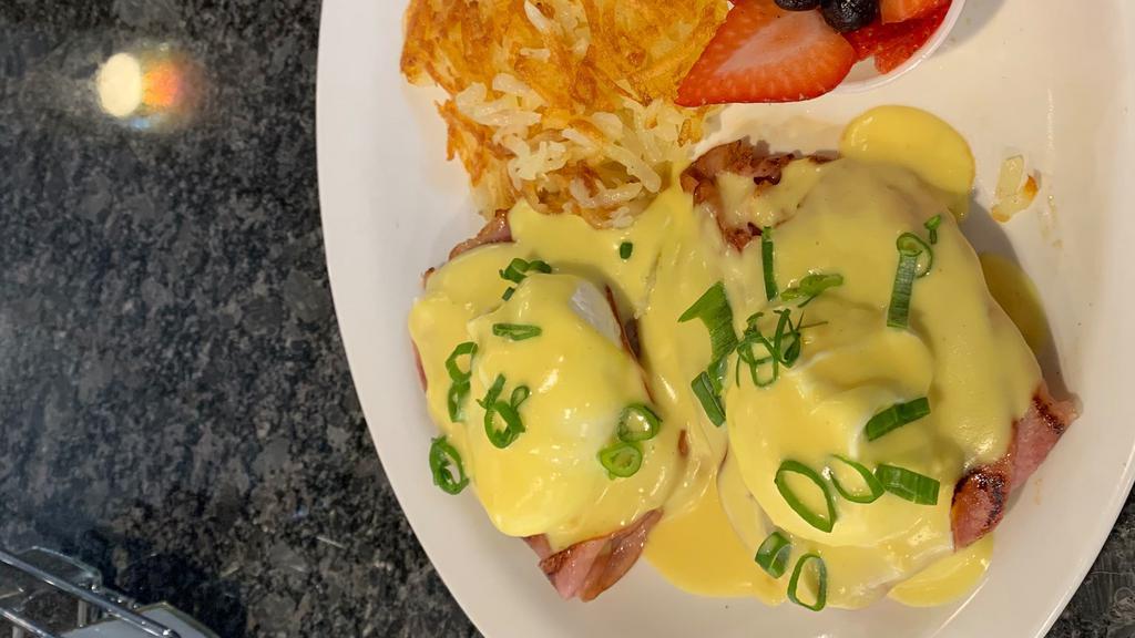 Classic Eggs Benedict · Two Poached Eggs, Ham, and Hollandaise sauce served on an english muffin with a side of Hashbrowns