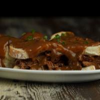 Hot Roast Beef Sandwich · Slow Roasted Beef, served on two slices of bread with mashed potatoes and gravy.