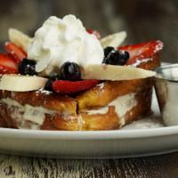 Cream Cheese Stuffed French Toast · 2 slices of French toast stuffed with our sweet cream cheese and topped with bananas, strawb...
