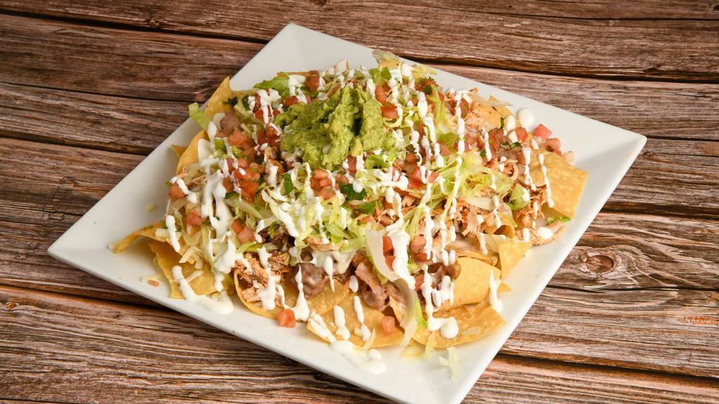 Nachos · Chips covered with beans, mozzarella cheese and your choice of meat. Topped with pico de gallo, sour cream, shredded lettuce, and guacamole.