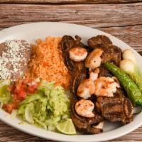 Costillas Con Camarones · Beef ribs with shrimp. Served with rice, beans, side salad and tortillas.
