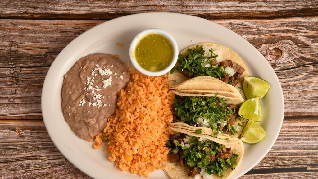 Combo Taco · (3) soft corn or flour taco, with your choice of meats. Topped with onion, cilantro, served with rice, beans, limes, and salsas.