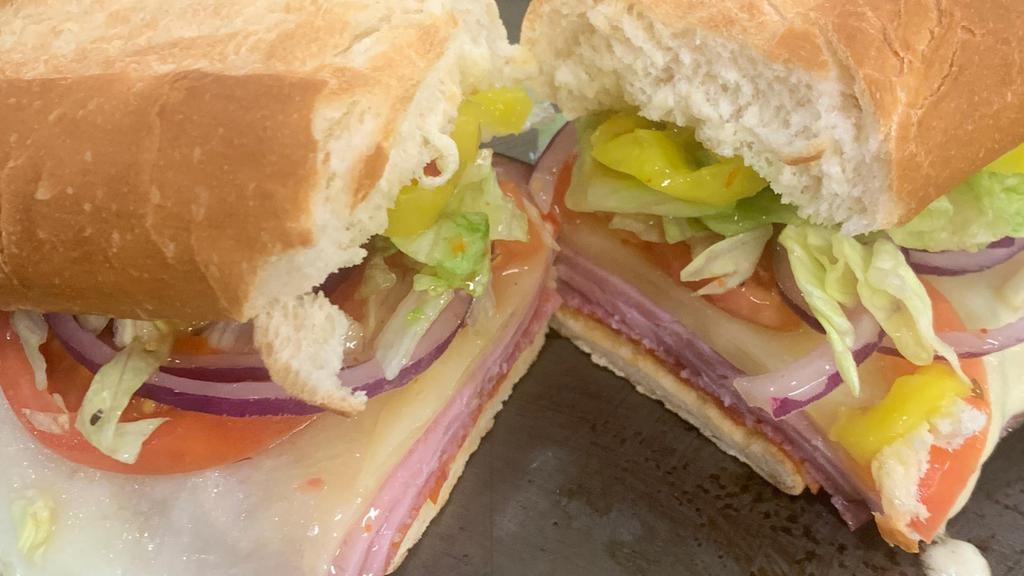 The Straight Italian · Our straight Italian baler topped with sliced pepperoni, hard salami and sliced ham on a fresh local toasted sub bun with melted provolone.