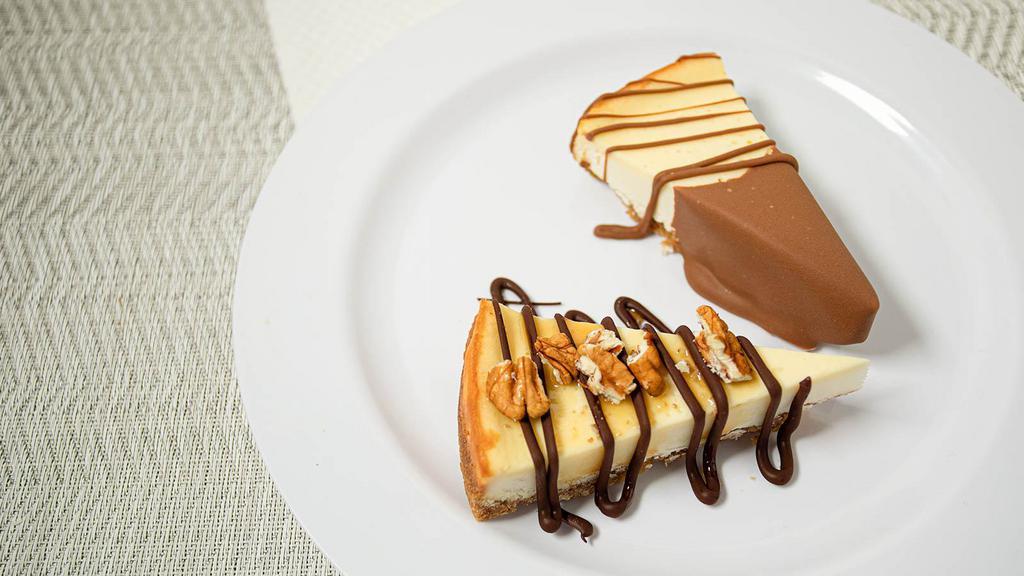 Cheesecake · A classic cheesecake made with real cream cheese and a graham cracker crust, drizzled in our Belgian chocolate!