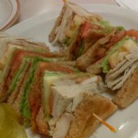 Turkey Club Sandwich · Tripled decker, turkey, bacon, mayonnaise, lettuce and tomato on white toastWith fries.