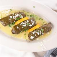 Dolmadaka (Stuffed Grape Leaves) · Grape leaves stuffed with lean ground beef, lamb, rice, and Greek herbs, then topped with av...