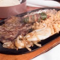 Carne Asada Skillet · Thin skirt steak cooked with grilled onions with a jalapeño popper on top. Served with refri...
