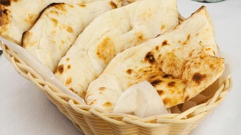 Naan Bread · Leavened white bread baked in tandoor oven.