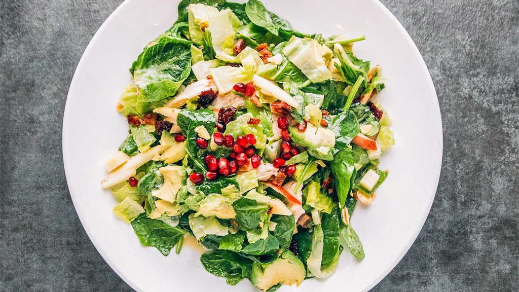 Chopped Chicken Salad · Oven roasted chicken, dried cherries, spinach, romaine, bacon, avocado, fontina and crisp red apple tossed in citrus vinaigrette with toasted almonds finished with pomegranate seeds.