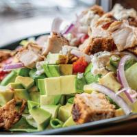 Blackened Chicken Cobb · fresh romain lettuce tossed in blue cheese
dressing then layered over the top with avocados,...