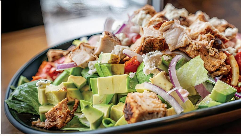 Blackened Chicken Cobb · fresh romain lettuce tossed in blue cheese
dressing then layered over the top with avocados,
roasted tomatoes, chopped hard boiled eggs,
ham, bacon, blue cheese crumbles, blackened
chicken breast, and red onions