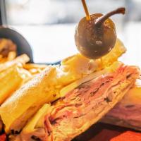 Cuban Sandwich · shaved ham, pulled pork, Swiss cheese, & 
thinly sliced pickles, piled high on a baguette 
w...