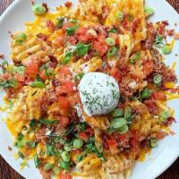 Idaho Nachos Appetizer · crispy waffle fries piled high with melted cheddar jack cheese, bacon, roma tomato, green on...