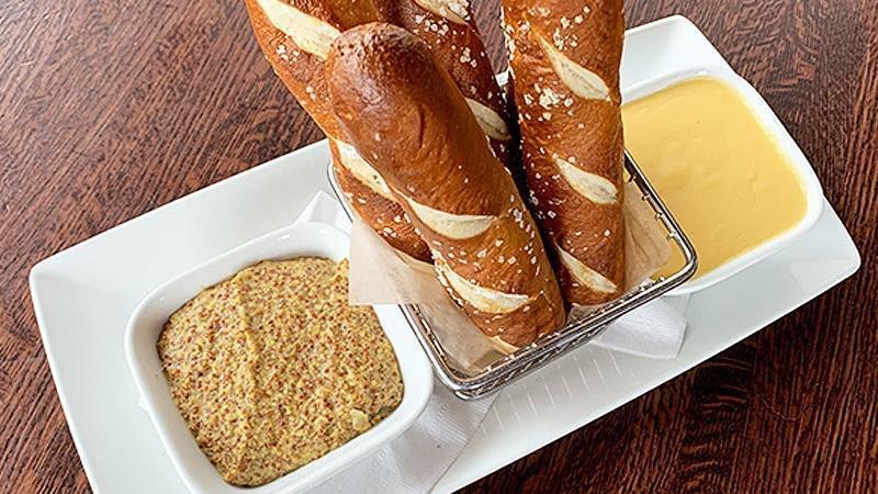 Pretzel Sticks Appetizer · soft salted pretzel sticks served with our house-made, northern lager-infused cheese sauce and mustard infused with our award-winning bock beer.