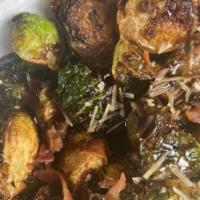 Crispy Brussels Sprouts Appetizer · Flash-fried brussels sprouts tossed with a balsamic dressing and millionaire’s bacon. Garnis...