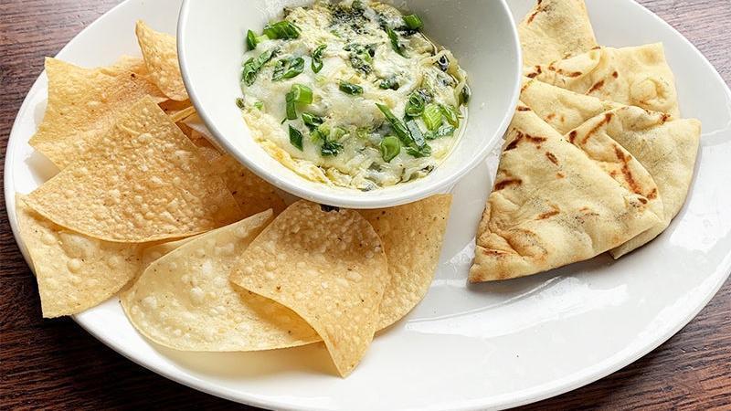 Spinach & Artichoke Dip Appetizer · creamy spinach, artichoke and parmesan dip. served with grilled naan bread and crispy tortilla chips.