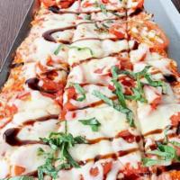Margherita Flatbread Appetizer · fresh roma tomato, marinara, mozzarella and provolone cheeses, balsamic glaze and fresh basi...