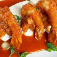 Crispy Buffalo Shrimp Appetizer · lightly fried jumbo shrimp tossed in buffalo sauce. served over bleu cheese dressing.