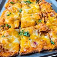 Bbq Chicken Flatbread Appetizer · BBQ-tossed chicken, red onion, cheddar and jack cheeses and fresh cilantro on a BBQ sauce-br...
