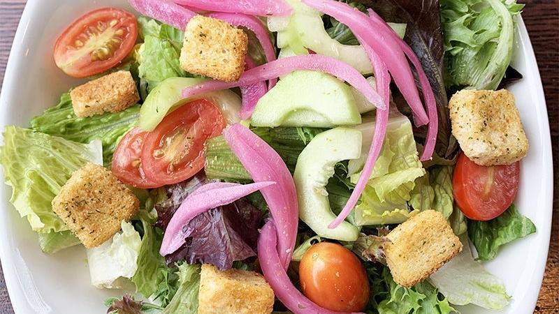 House Salad · Romaine lettuce, arcadian greens, sliced grape tomato, cucumber, pickled red onion, and crunchy garlic croutons. Served with your choice of house-made dressing.