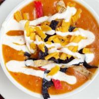 Cheesy Chicken Tortilla Soup · made with roasted chicken, red chilis, cream and cheddar cheese. topped with crunchy tortill...