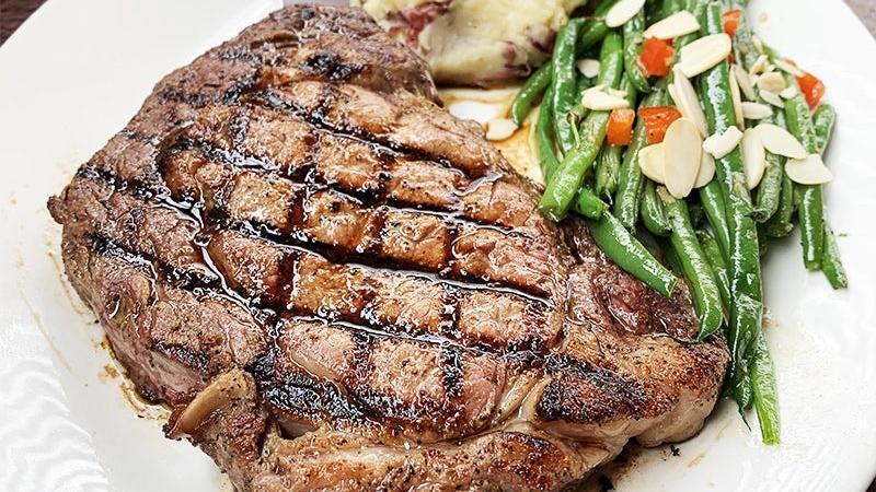 Ribeye · 14 oz. USDA Choice boneless ribeye steak, served with redskin mashed potatoes and green beans almondine