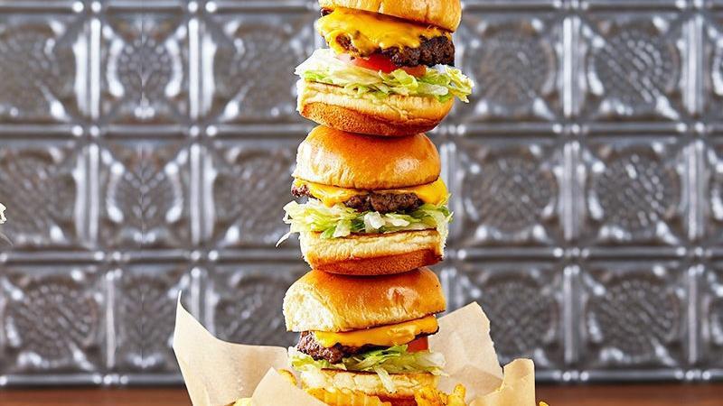 Cheeseburger Slider Tower · Juicy hamburger patties on brioche slider buns. Stacked high with crisp lettuce, onion, roma tomatoes, and American cheese. Served over french fries.