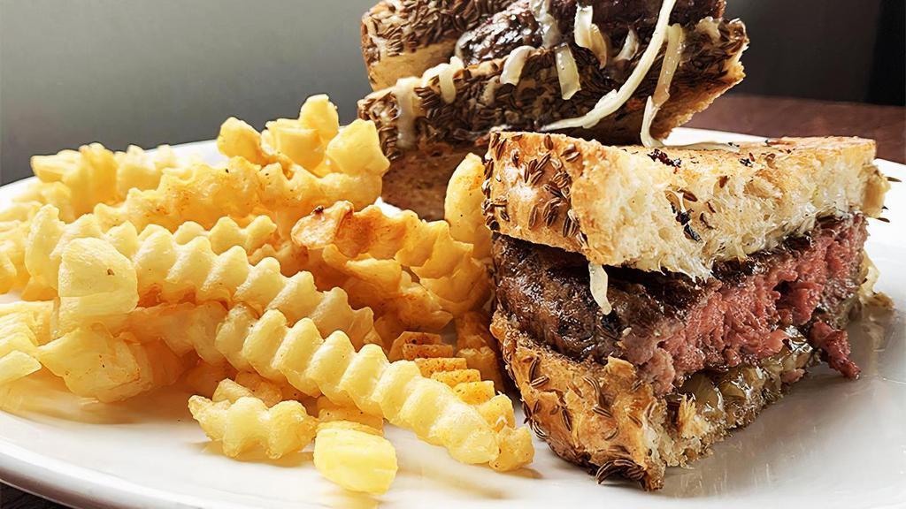 Patty Melt · Half-pound GC signature beef blend, stacked with caramelized onions and melted white cheddar cheese on golden grilled caraway rye bread.