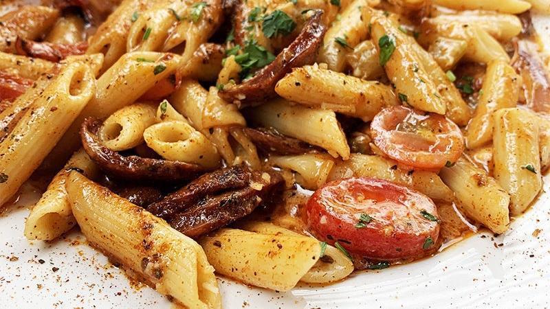 Cajun Pasta · sautéed andouille sausage and tender chicken, red onion, bell pepper and grape tomato, simmered in our creamy cajun sauce and tossed with penne pasta.
