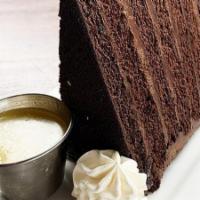 Chocolate Cake · Decadent chocolate layer cake with bourbon caramel sauce and a touch of whipped cream.