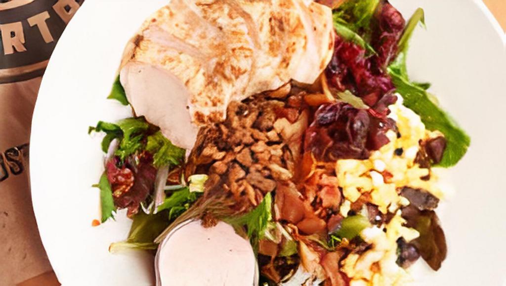 Applewood Chicken Salad · Applewood smoked bacon and thick slices of grilled chicken top this salad of mixed greens with spiced pecans, dried cranberries, blue cheese crumbles, and a chopped hard-boiled egg. Comes with a side of cranberry poppyseed dressing. 